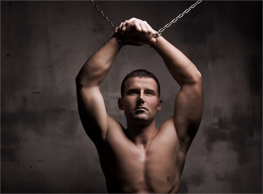 تصویر با کیفیت از مرد بدنساز در حال تمرین با بدن ورزیده و زنجیر