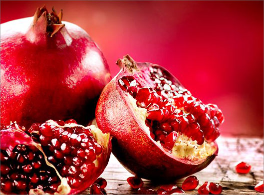 عکس با کیفیت از انار درسته و نصف انارهای شب یلدا