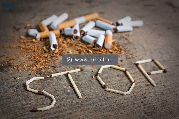 تصویر با کیفیت از عکس نمادین ته سیگار و کلمه stop با کبریت