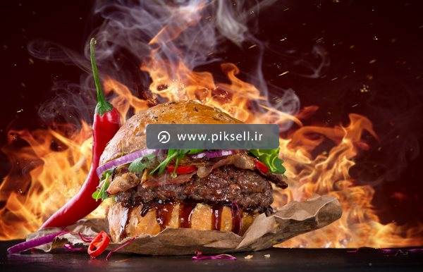عکس با کیفیت از همبرگر گوشت و بکگراند آتش